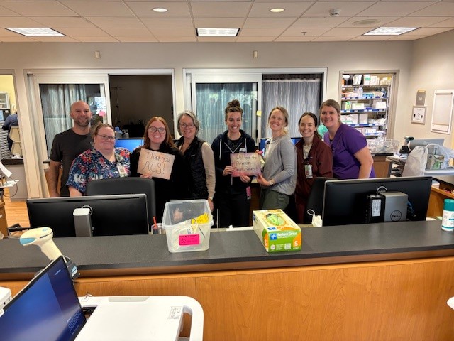 people holding up signs thanking the American Cancer Society 
