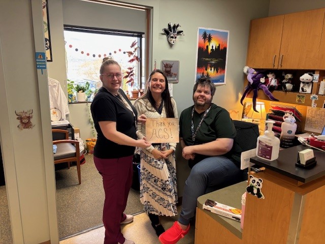 people holding up signs thanking the American Cancer Society 