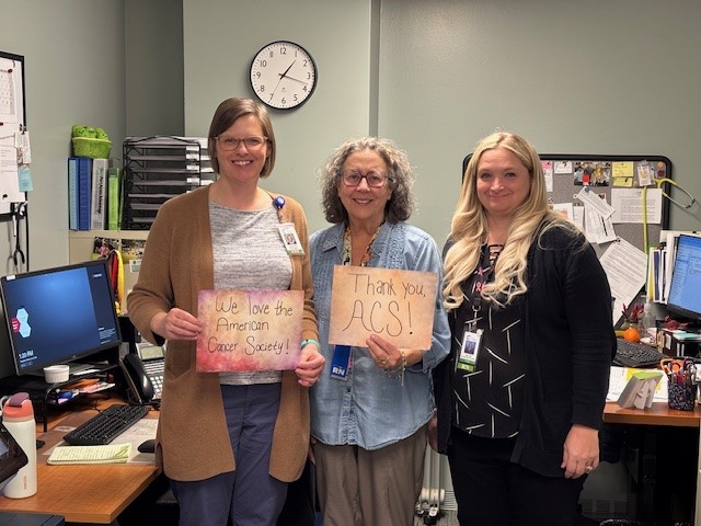 people holding up signs thanking the American Cancer Society 